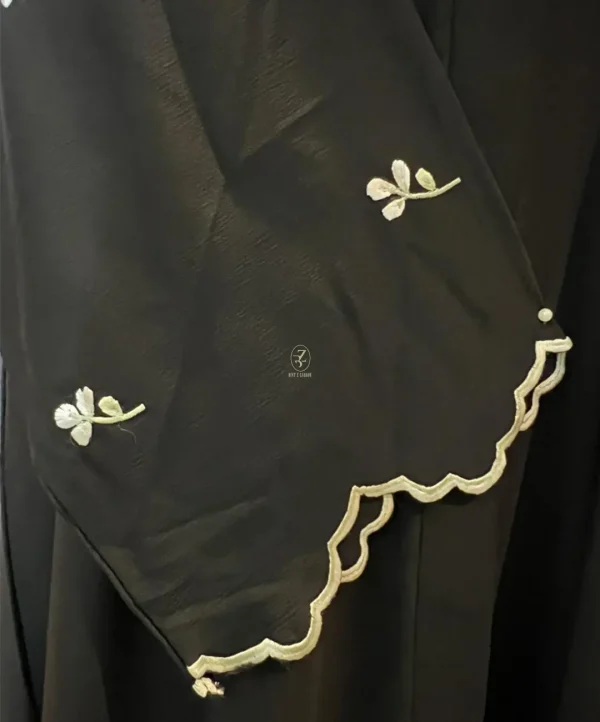 Black-and-Sage-Embroidered-&-Scallop-Abaya-closeup-sleeves-view close up sleeve view of black and sage embroidered scallop abaya